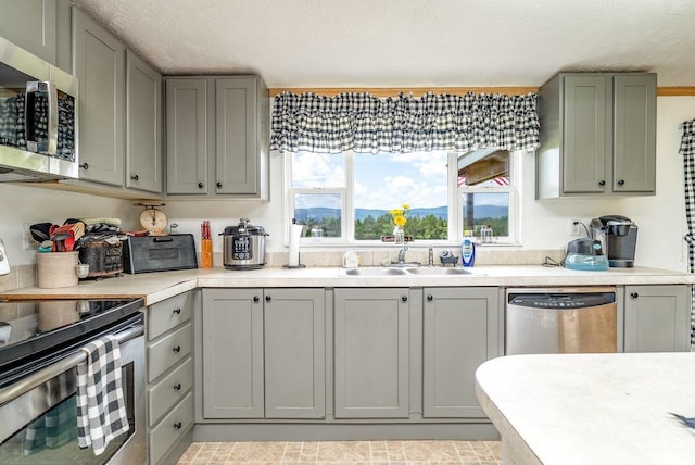3930 Williams Ln, Elkton, VA 22827 - kitchen with appliances with stainless steel finishes, gray cabinetry, light countertops, and a textured ceiling