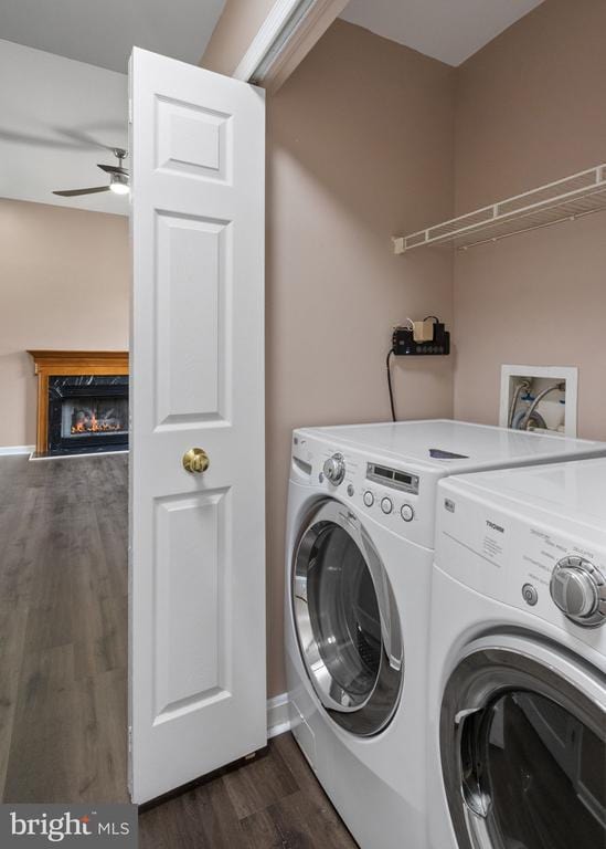 7306 Pullen Dr, Fredericksburg, VA 22407 - laundry area featuring washing machine and clothes dryer, a glass covered fireplace, dark wood-type flooring, ceiling fan, and baseboards