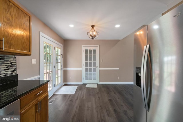 7306 Pullen Dr, Fredericksburg, VA 22407 - kitchen with stainless steel fridge, dark wood finished floors, backsplash, brown cabinets, and baseboards