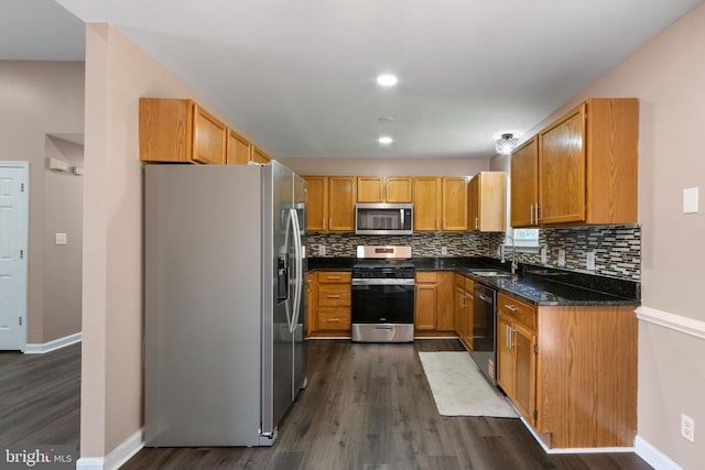 7306 Pullen Dr, Fredericksburg, VA 22407 - kitchen with stainless steel appliances, dark wood-style floors, a sink, and decorative backsplash