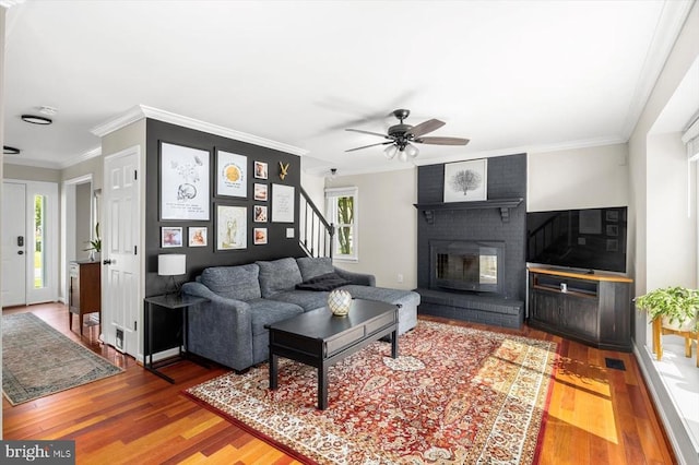 11814 Arbor Glen Dr, Fredericksburg, VA 22407 - living area featuring wood finished floors, stairs, a ceiling fan, crown molding, and a brick fireplace