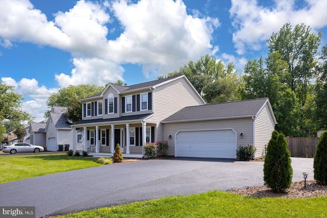 11814 Arbor Glen Dr, Fredericksburg, VA 22407 - colonial house featuring a porch, an attached garage, and driveway