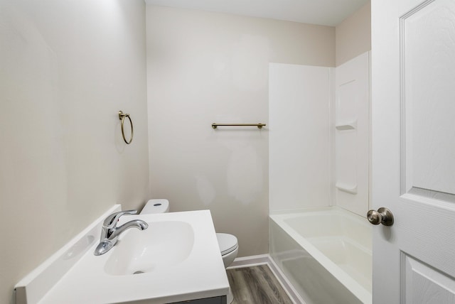 full bathroom featuring shower / bathtub combination, toilet, baseboards, vanity, and wood finished floors