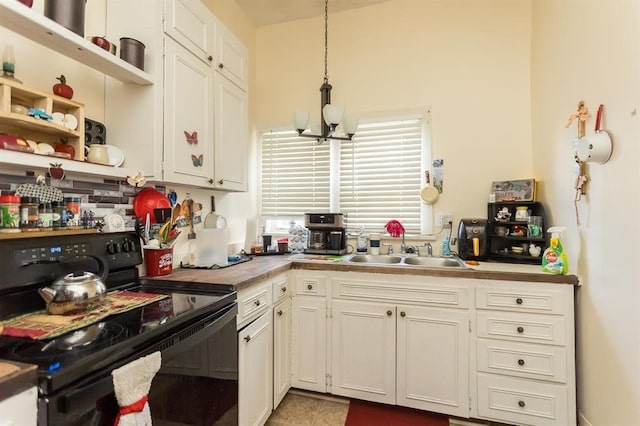 kitchen with a sink, open shelves, white cabinetry, black range with electric cooktop, and a notable chandelier