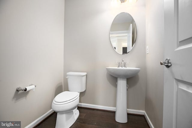 6056 Greenspring Rd, Fredericksburg, VA 22407 - half bath with baseboards, toilet, wood finished floors, and a sink