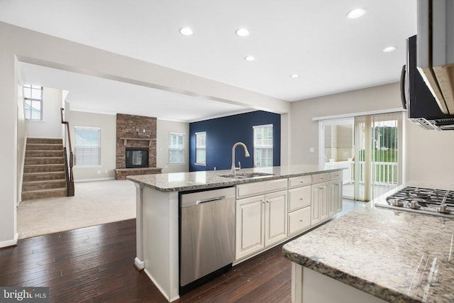 6056 Greenspring Rd, Fredericksburg, VA 22407 - kitchen featuring stainless steel appliances, a sink, light stone counters, dark wood-type flooring, and an island with sink
