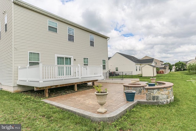 6056 Greenspring Rd, Fredericksburg, VA 22407 - back of property featuring an outdoor fire pit, a patio, a wooden deck, a yard, and a storage unit