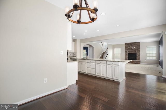 6056 Greenspring Rd, Fredericksburg, VA 22407 - kitchen with a chandelier, dark wood-style flooring, a sink, white cabinets, and recessed lighting