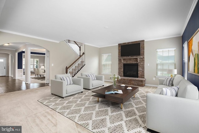 6056 Greenspring Rd, Fredericksburg, VA 22407 - living area with arched walkways, healthy amount of natural light, crown molding, baseboards, and a stone fireplace