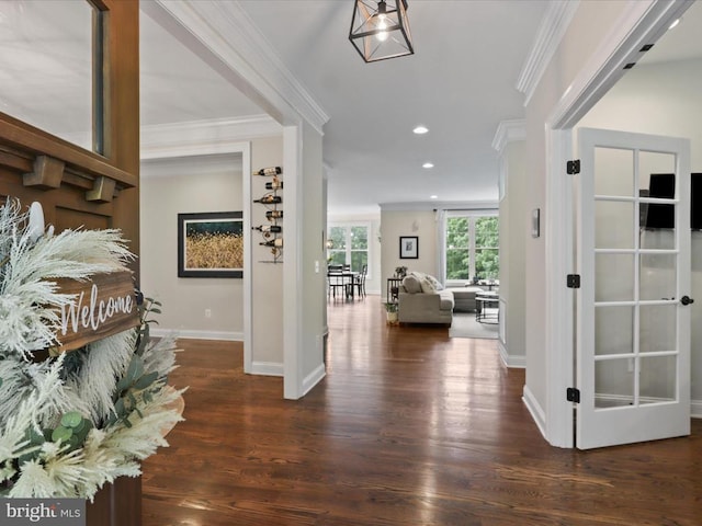 foyer entrance with crown molding, wood finished floors, baseboards, and recessed lighting