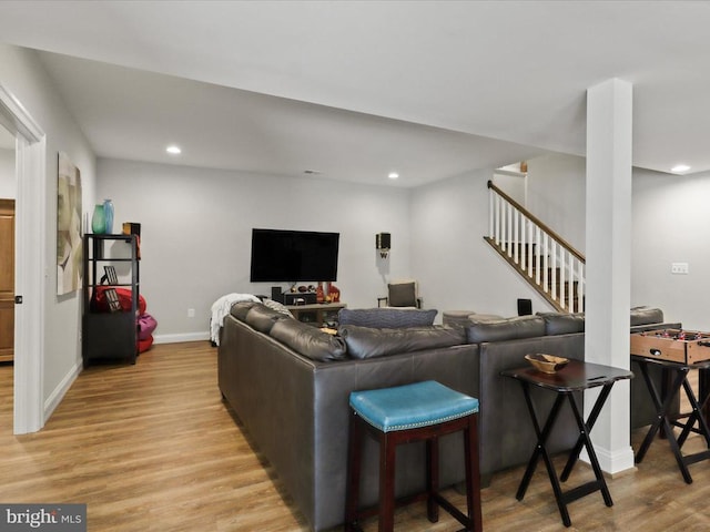 living room featuring light wood-style flooring, stairs, recessed lighting, and baseboards