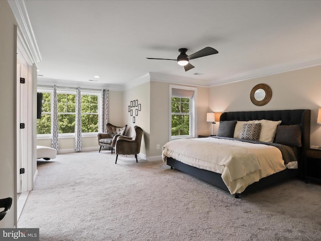 carpeted bedroom featuring crown molding, baseboards, and a ceiling fan