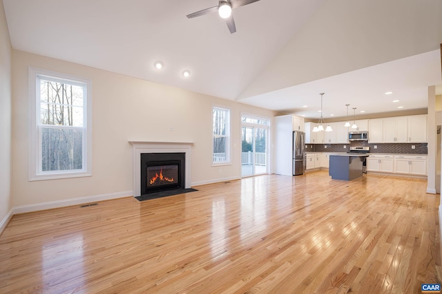 212 Bartholomew Pl, Stanardsville, VA 22973 - unfurnished living room featuring ceiling fan, visible vents, light wood-style flooring, and a fireplace with flush hearth
