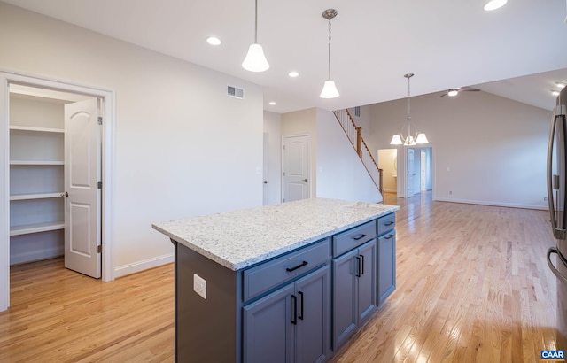 212 Bartholomew Pl, Stanardsville, VA 22973 - kitchen featuring light wood-type flooring, visible vents, blue cabinetry, a center island, and a notable chandelier