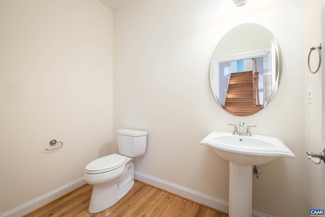 212 Bartholomew Pl, Stanardsville, VA 22973 - bathroom featuring toilet, baseboards, and wood finished floors