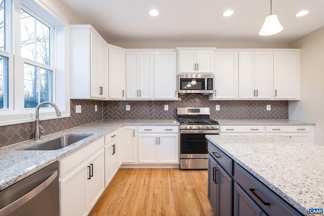 212 Bartholomew Pl, Stanardsville, VA 22973 - kitchen with a sink, stainless steel appliances, light wood-type flooring, white cabinetry, and plenty of natural light
