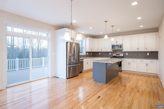 212 Bartholomew Pl, Stanardsville, VA 22973 - kitchen featuring white cabinetry, light wood finished floors, appliances with stainless steel finishes, and decorative backsplash