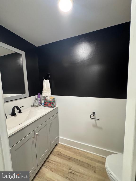 6612 Old Plank Rd, Fredericksburg, VA 22407 - bathroom featuring vanity, toilet, wood finished floors, and baseboards
