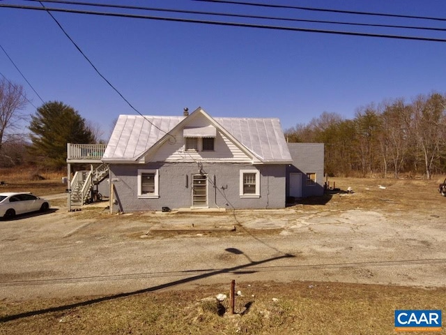 4823 Patrick Henry Hwy, Piney River, VA 22964 - view of front of house with stairway, a wooden deck, metal roof, and a chimney