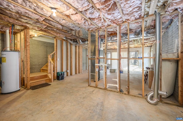 below grade area with stairs, water heater, and heating unit