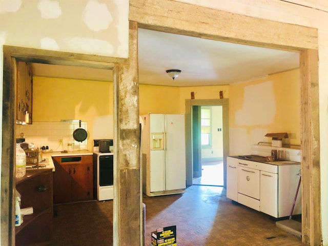 9264 Schuyler Rd, Schuyler, VA 22969 - kitchen with white refrigerator with ice dispenser, finished concrete flooring, light countertops, and white cabinetry