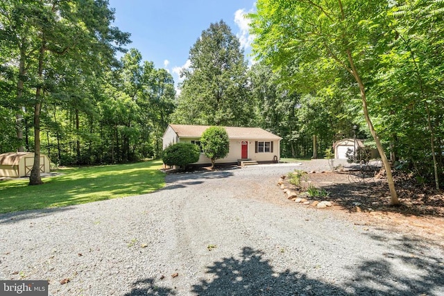 11248 Saint Pauls Rd, Remington, VA 22734 - view of front facade with gravel driveway, a storage shed, and a front yard