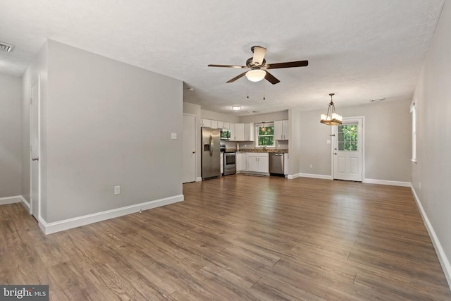 11248 Saint Pauls Rd, Remington, VA 22734 - unfurnished living room with ceiling fan, a chandelier, and dark wood-style floors