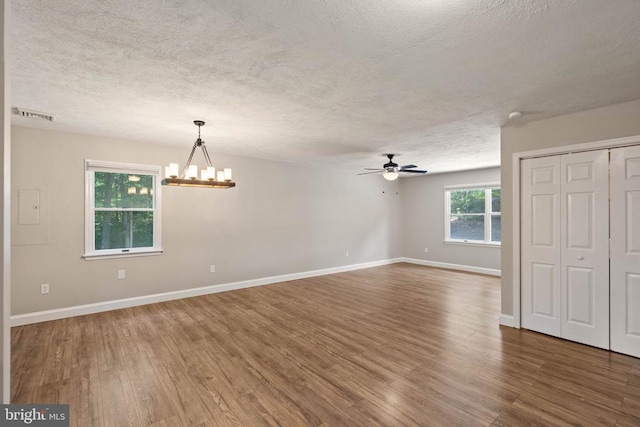 11248 Saint Pauls Rd, Remington, VA 22734 - unfurnished room with a textured ceiling, a chandelier, wood finished floors, and ceiling fan