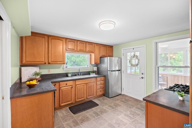 687 Gidsville Rd, Amherst, VA 24521 - kitchen featuring freestanding refrigerator, dark countertops, a sink, and brown cabinets