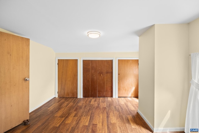 687 Gidsville Rd, Amherst, VA 24521 - unfurnished bedroom with two closets, wood finished floors, and baseboards