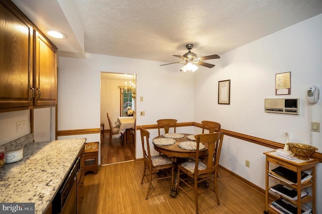 127 Gold Rush Dr, Locust Grove, VA 22508 - dining room with light wood finished floors, a ceiling fan, a chandelier, baseboards, and a textured ceiling
