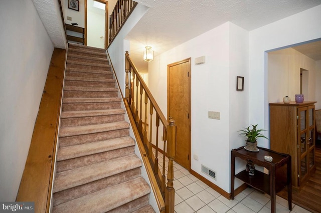 127 Gold Rush Dr, Locust Grove, VA 22508 - staircase featuring tile patterned floors, baseboards, and a textured ceiling