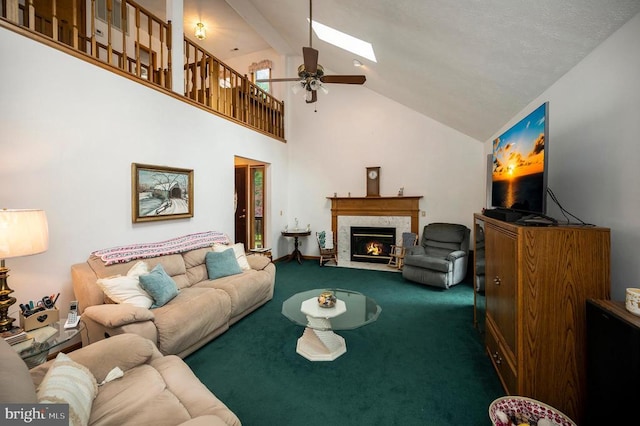 127 Gold Rush Dr, Locust Grove, VA 22508 - carpeted living area with a ceiling fan, a fireplace, high vaulted ceiling, and a skylight