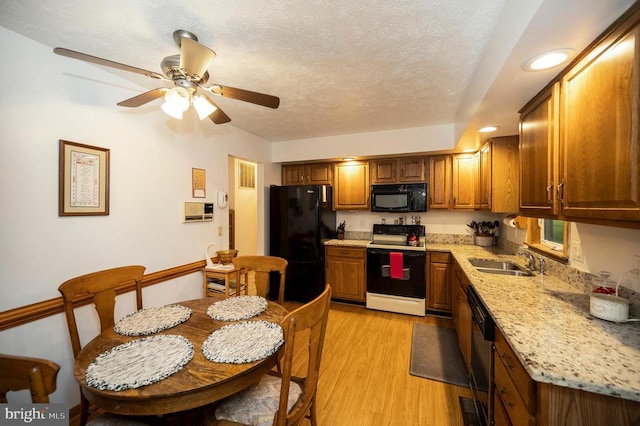 127 Gold Rush Dr, Locust Grove, VA 22508 - kitchen featuring black appliances, a sink, a ceiling fan, light wood finished floors, and brown cabinets