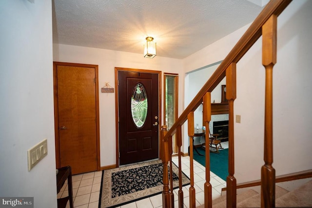 127 Gold Rush Dr, Locust Grove, VA 22508 - entryway featuring stairway, light tile patterned floors, a textured ceiling, and baseboards