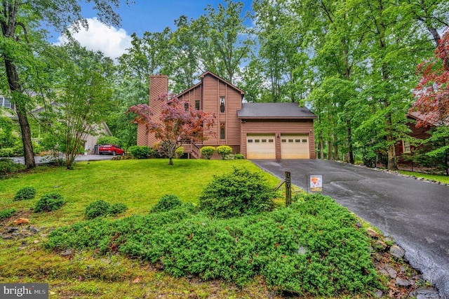 127 Gold Rush Dr, Locust Grove, VA 22508 - view of front of house featuring asphalt driveway, a garage, a chimney, and a front yard