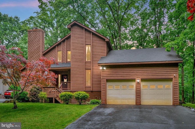 127 Gold Rush Dr, Locust Grove, VA 22508 - mid-century home with asphalt driveway, a chimney, a front yard, a garage, and roof with shingles