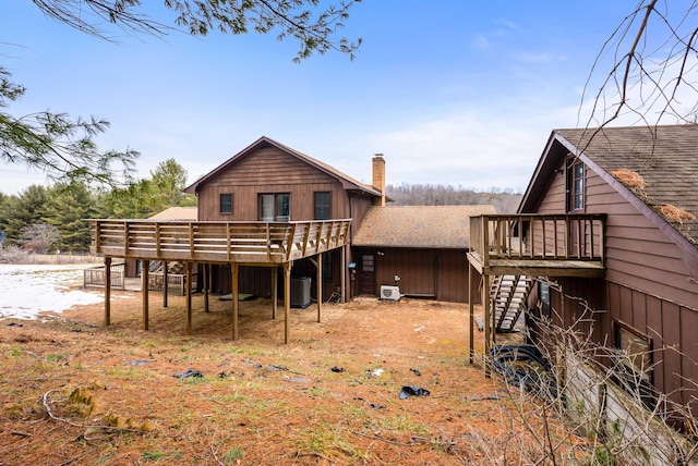 rear view of property with cooling unit and a deck