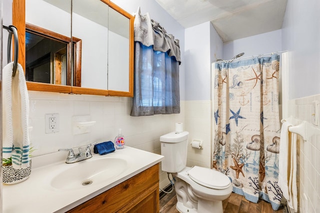 bathroom featuring vanity, tile walls, toilet, and walk in shower