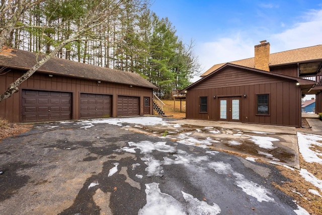 view of home's exterior with french doors and a garage