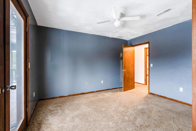 unfurnished room featuring light carpet and ceiling fan