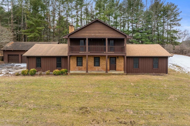 view of property featuring a garage and a front yard