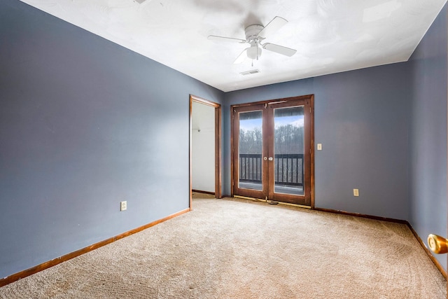 empty room with light colored carpet, ceiling fan, and french doors