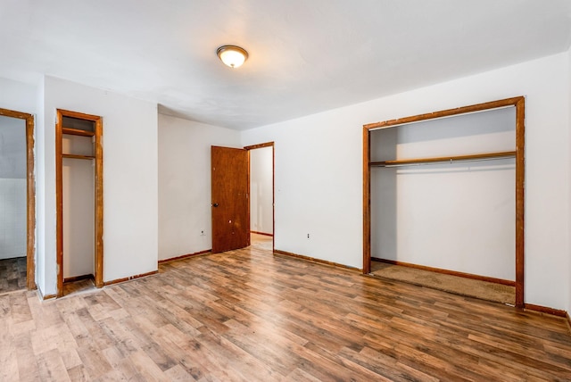 unfurnished bedroom with hardwood / wood-style flooring and a closet