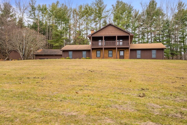 back of property featuring a lawn