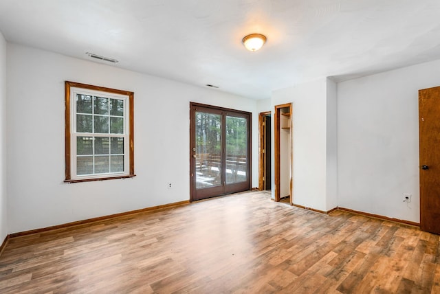 unfurnished room with light wood-type flooring