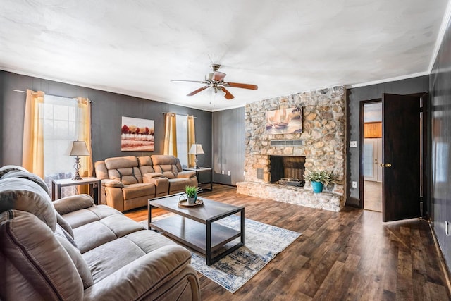 living room with ceiling fan, ornamental molding, a fireplace, and hardwood / wood-style floors