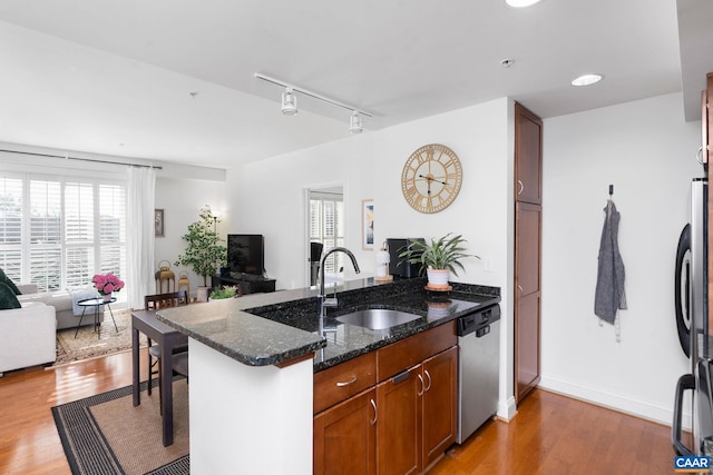 428 Monroe Ln Unit 306, Charlottesville, VA 22902 - kitchen with a peninsula, light wood finished floors, a sink, open floor plan, and appliances with stainless steel finishes