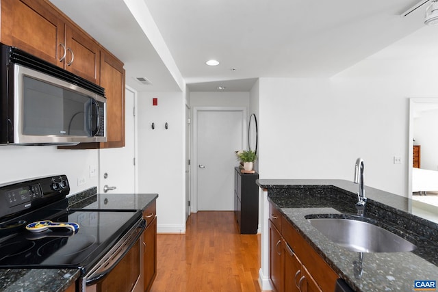 428 Monroe Ln Unit 306, Charlottesville, VA 22902 - kitchen with a sink, visible vents, stainless steel microwave, light wood-style floors, and range with electric stovetop
