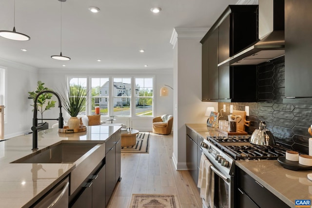 43 Farrow Cir, Charlottesville, VA 22901 - kitchen with ornamental molding, light stone counters, a sink, wall chimney range hood, and appliances with stainless steel finishes